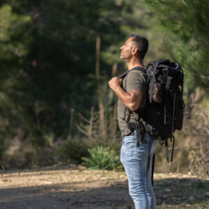 A solo traveler enjoying the nature in forest.
