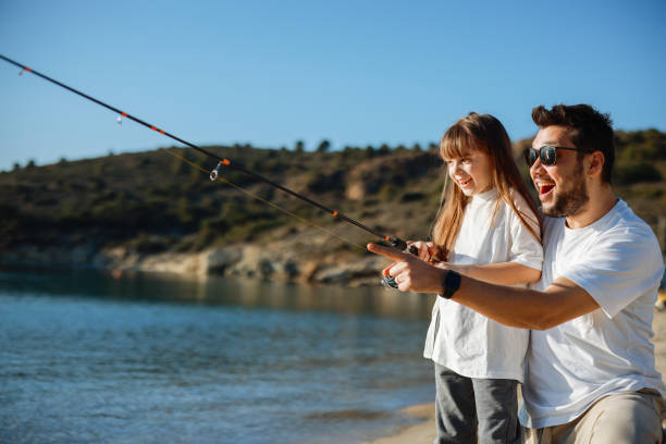 Father and dauther going to fish together with all needed equipment.